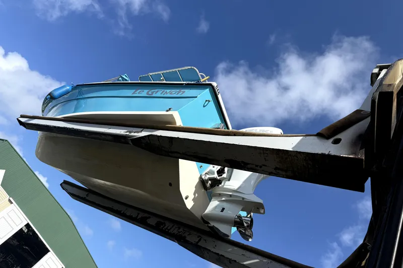 Slide: The Image of 2005 Angler 204 Center Console boat on trailer, parked beside a house. - 3