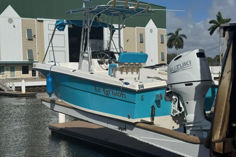 Slide: The Image of 2005 Angler 204 Center Console boat named "Le Grinch" lifted at marina. - 7