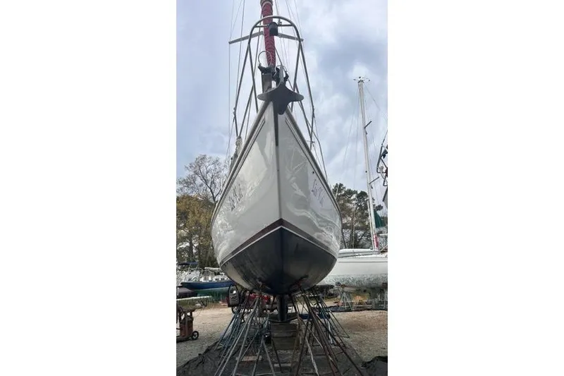Slide: The Image of 1998 Catalina 42 sailboat on stands, viewed from the bow, in a boatyard. - 10