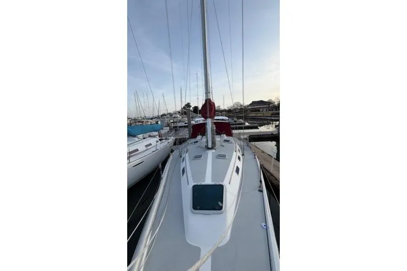Slide: The Image of 1998 Catalina 42 sailboat docked at marina, view of deck and mast. - 14