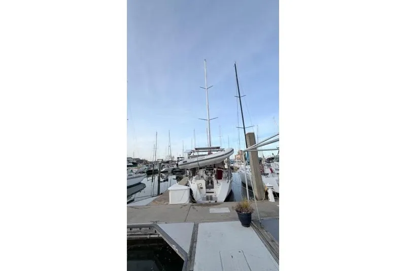 Slide: The Image of Docked 1998 Catalina 42 sailboat with tall mast in marina setting. - 3