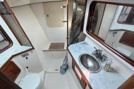 Slide: The Image of Bathroom interior of 1998 Catalina 42 sailboat with sink, toilet, and shower. - 30