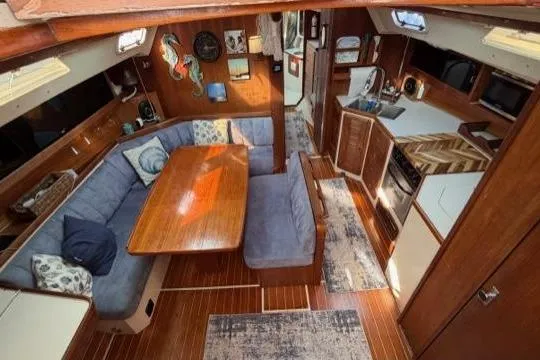 Slide: The Image of Interior of 1998 Catalina 42 sailboat with cozy seating and wooden finishes. - 32