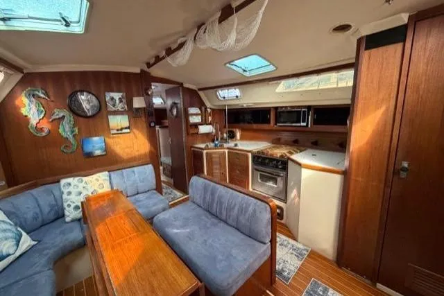 Slide: The Image of Interior of a 1998 Catalina 42 sailboat with cozy seating and wooden finishes. - 35