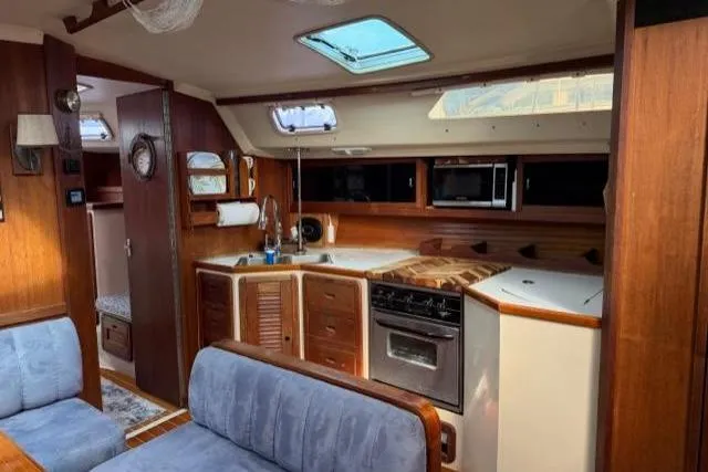 Slide: The Image of Interior of 1998 Catalina 42 sailboat with kitchen and seating area. - 36
