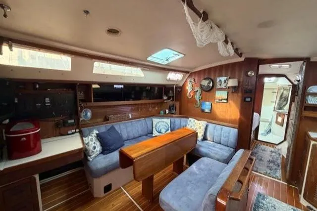 Slide: The Image of Interior of 1998 Catalina 42 sailboat with cozy seating and wooden accents. - 37