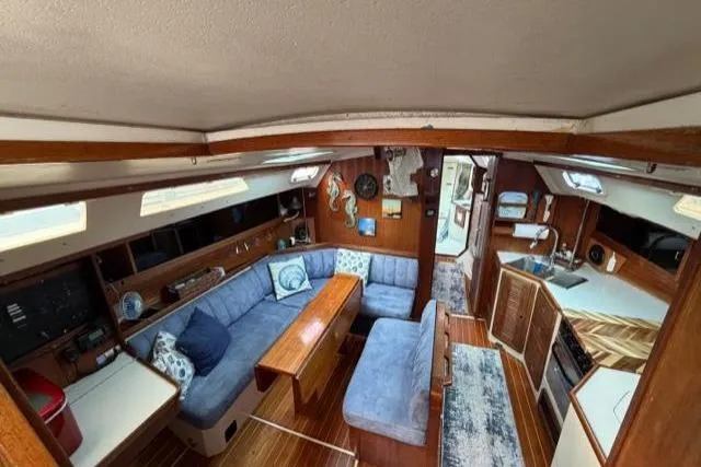Slide: The Image of Interior of 1998 Catalina 42 sailboat with cozy seating and wooden accents. - 39