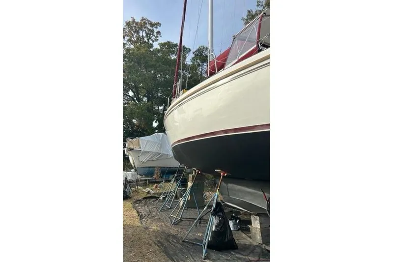 Slide: The Image of 1998 Catalina 42 sailboat on stands, undergoing maintenance in a boatyard. - 6