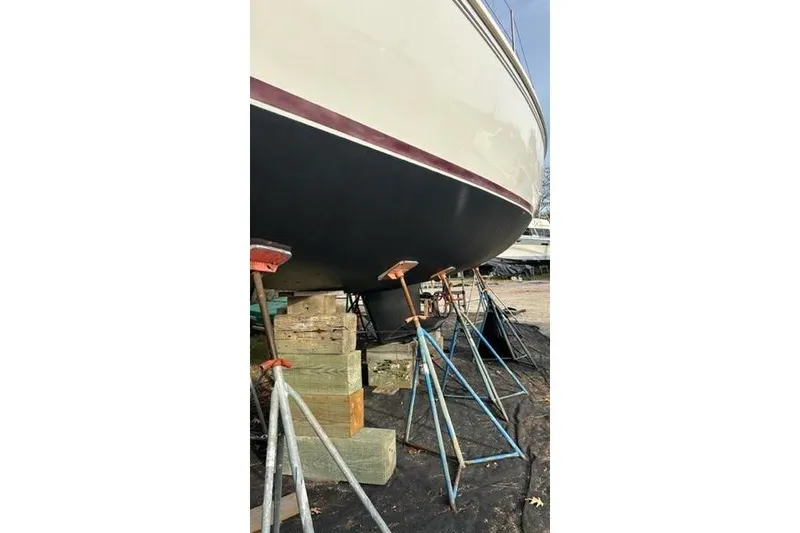 Slide: The Image of 1998 Catalina 42 sailboat on stands, hull view in a boatyard. - 9