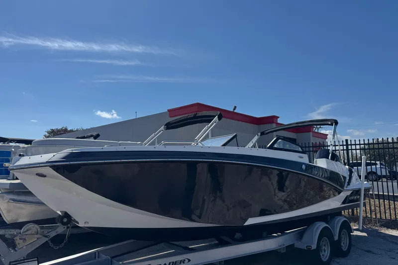 The Image of 2020 Glastron GTD 240 boat on trailer under clear blue sky. - 1