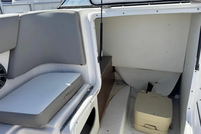 Slide: The Image of 2020 Glastron GTD 240 boat interior with seating and portable toilet. - 11