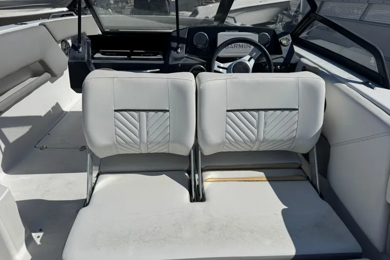 Slide: The Image of 2020 Glastron GTD 240 boat interior with dual seats and steering wheel. - 12
