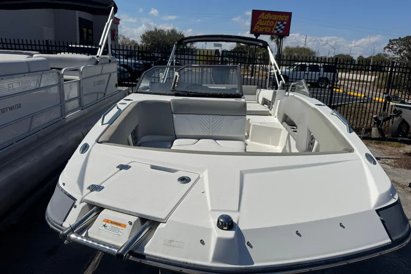 Slide: The Image of 2020 Glastron GTD 240 boat displayed outdoors near auto parts store. - 6