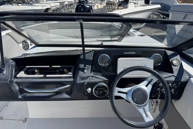 Slide: The Image of 2020 Glastron GTD 240 boat dashboard with steering wheel and control panel. - 7
