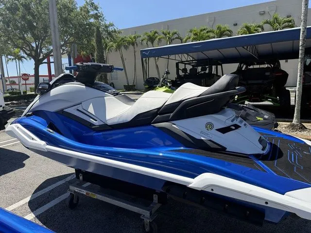 Slide: The Image of 2021 Yamaha WaveRunner FX Cruiser HO in blue and white parked outdoors. - 4