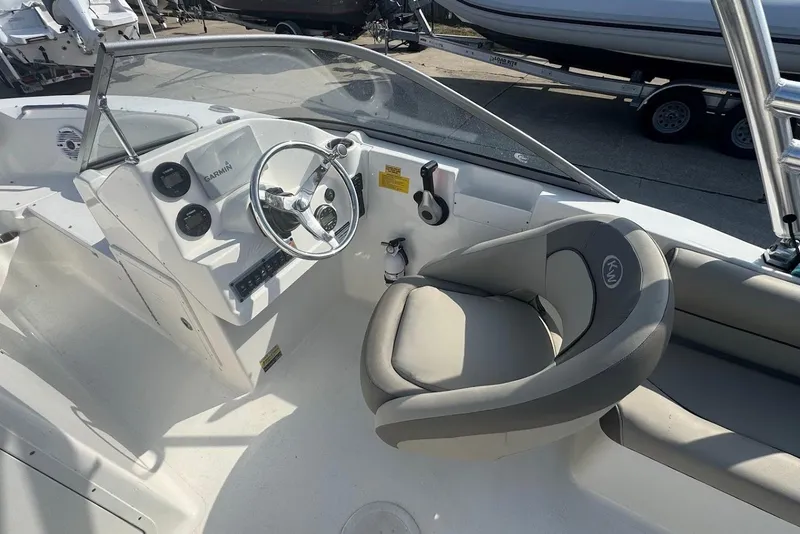 Slide: The Image of 2021 Key West 203 DFS boat interior with steering wheel and seating. - 10