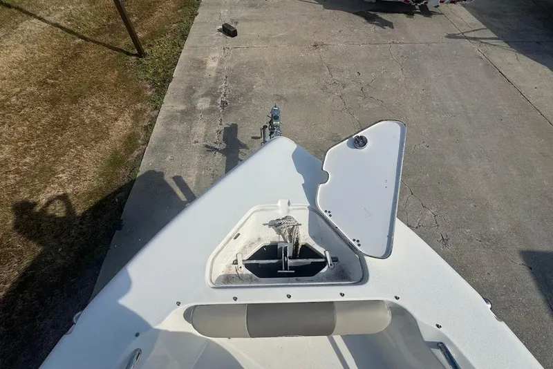 Slide: The Image of 2021 Key West 203 DFS boat bow with open anchor locker on concrete surface. - 17