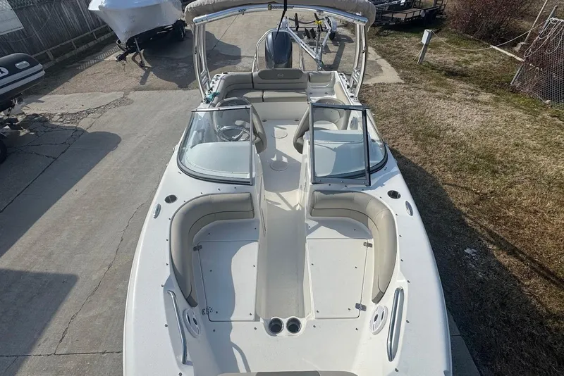 Slide: The Image of 2021 Key West 203 DFS boat with open deck and seating, parked on concrete. - 18