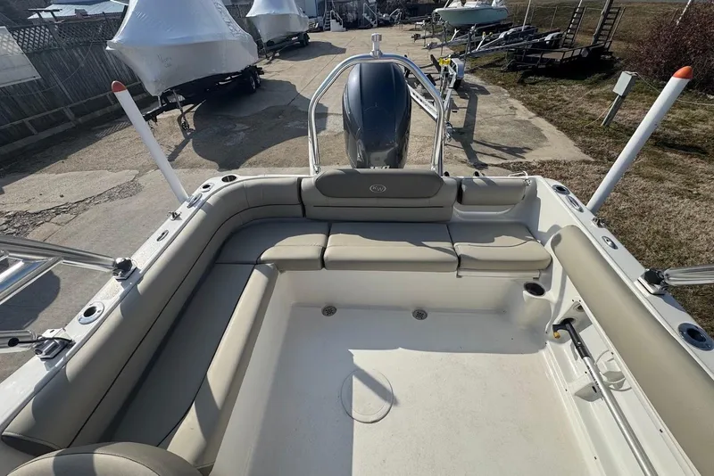 Slide: The Image of 2021 Key West 203 DFS boat interior with beige seating and outboard motor. - 9