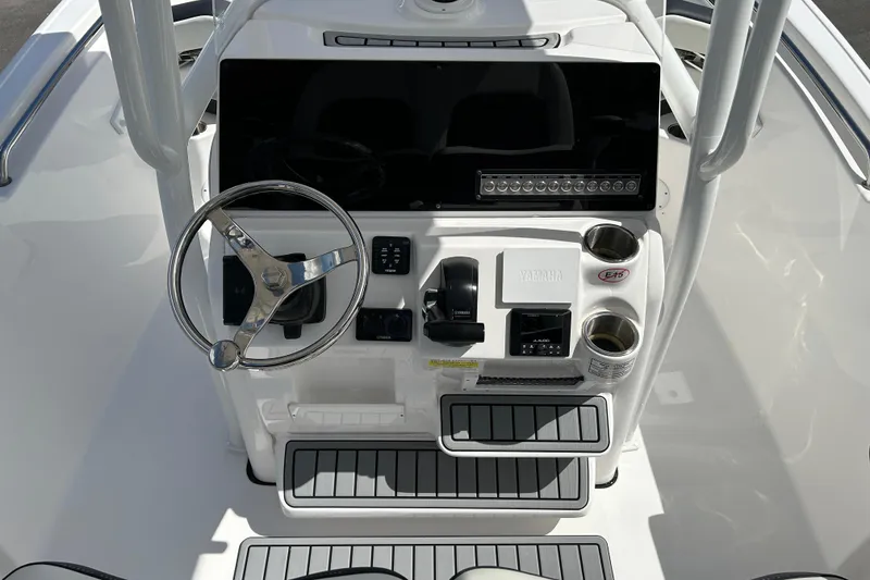 Slide: The Image of 2024 Tidewater 220 LXF boat console with steering wheel and controls. - 10