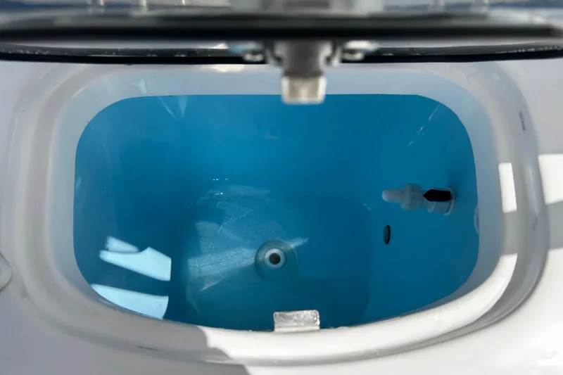 Slide: The Image of Livewell of 2024 Tidewater 220 LXF boat, featuring a clean, blue interior. - 16