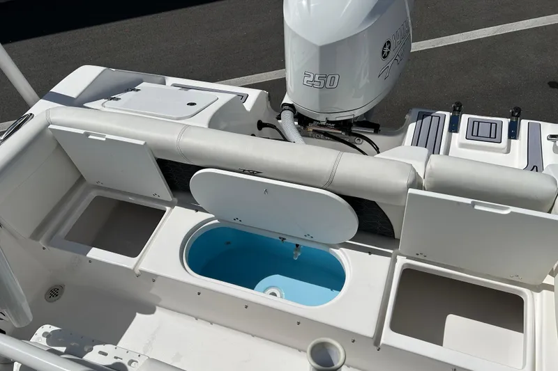 Slide: The Image of 2024 Tidewater 220 LXF boat interior with Yamaha 250 engine and storage compartments. - 17