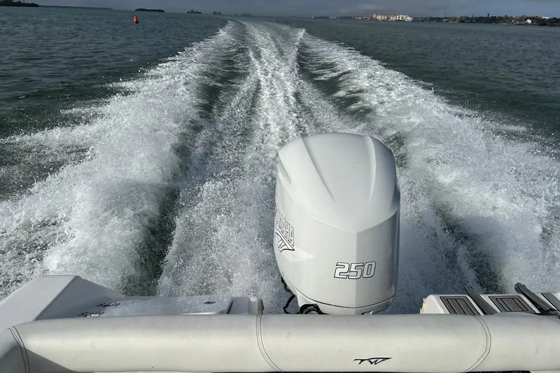 Slide: The Image of 2024 Tidewater 220 LXF boat cruising with powerful 250 engine on open water. - 20