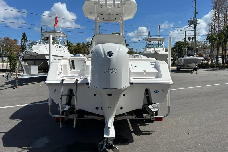 Slide: The Image of 2024 Tidewater 220 LXF boat with Yamaha 250 engine, parked outdoors under blue sky. - 3