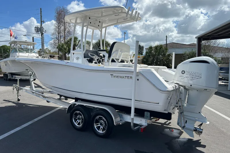 Slide: The Image of 2024 Tidewater 220 LXF boat with Yamaha engine on trailer, parked outdoors. - 4