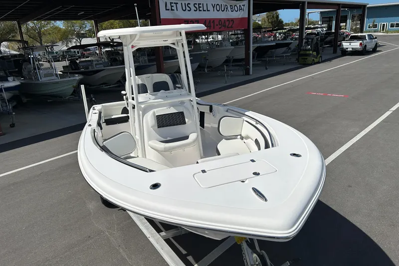 Slide: The Image of 2024 Tidewater 220 LXF boat displayed at a dealership, showcasing sleek design and spacious seating. - 6