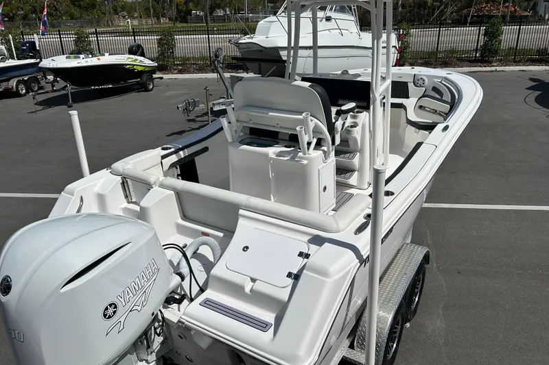 Slide: The Image of 2024 Tidewater 220 LXF boat with Yamaha engine, parked on a trailer. - 7