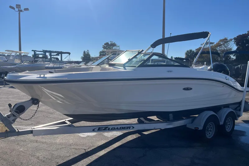 Slide: The Image of 2020 Sea Ray SPX 210 boat on trailer in sunny marina setting. - 3