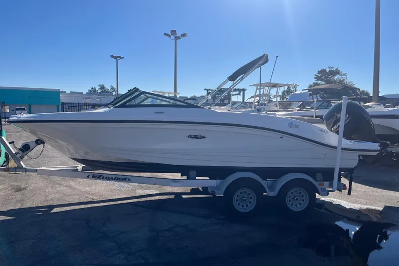 Slide: The Image of 2020 Sea Ray SPX 210 boat on trailer in sunny marina setting. - 4