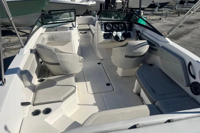Slide: The Image of 2020 Sea Ray SPX 210 boat interior with seating and steering console. - 7