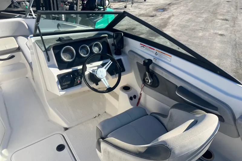 Slide: The Image of 2020 Sea Ray SPX 210 boat interior with steering wheel and dashboard controls. - 8
