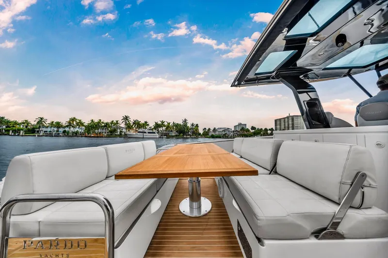 Slide: The Image of Luxurious 2021 Pardo Yachts 38 with elegant seating and scenic waterfront view. - 21