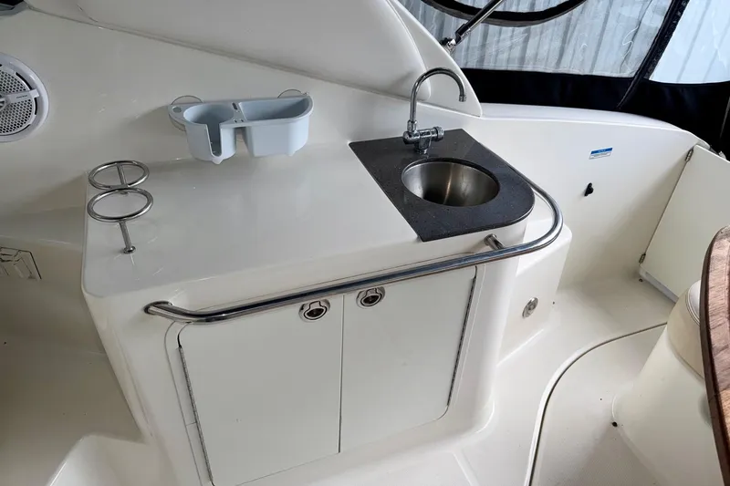 Slide: The Image of 2012 Sea Ray Sundancer 280 boat interior with sink and storage area. - 11