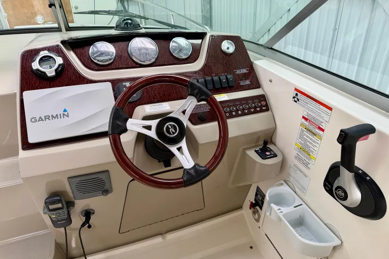 Slide: The Image of 2012 Sea Ray Sundancer 280 helm with Garmin navigation and wood-accented steering wheel. - 18