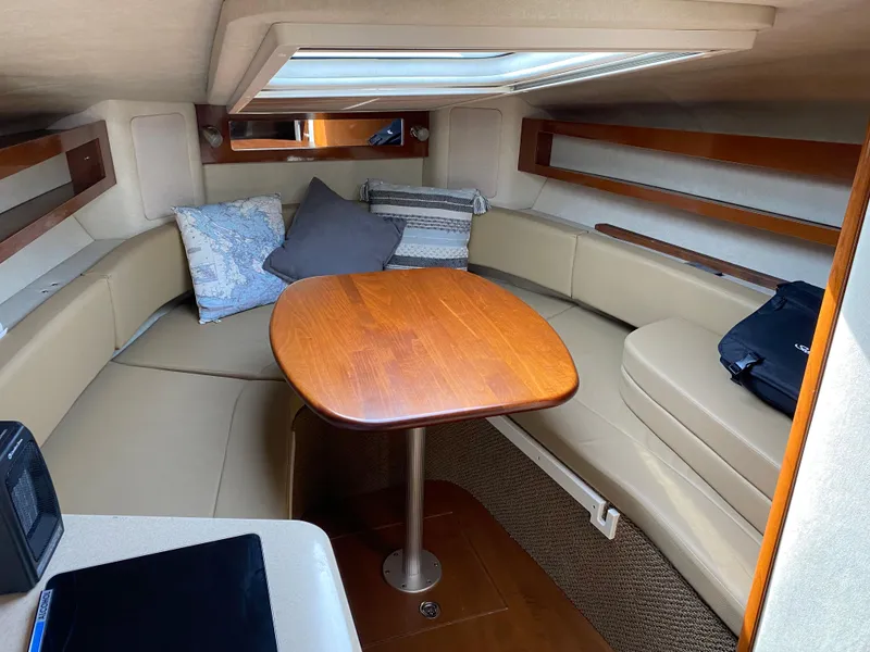 Slide: The Image of Interior of a 2012 Sea Ray Sundancer 280 with table and seating area. - 23