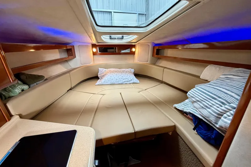Slide: The Image of Interior cabin of 2012 Sea Ray Sundancer 280 with cozy seating and ambient lighting. - 29