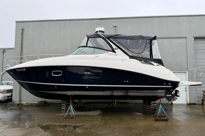 Slide: The Image of 2012 Sea Ray Sundancer 280 boat on stands, displayed outdoors. - 3