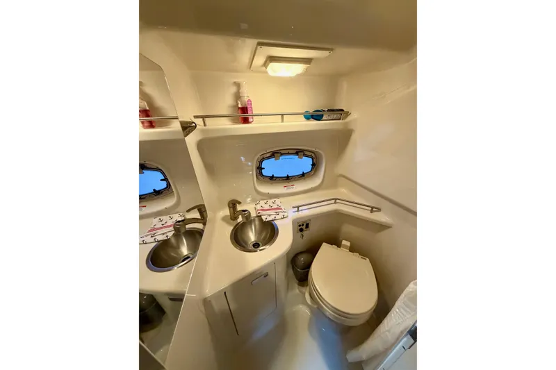 Slide: The Image of 2012 Sea Ray Sundancer 280 bathroom with sink, toilet, and porthole window. - 39