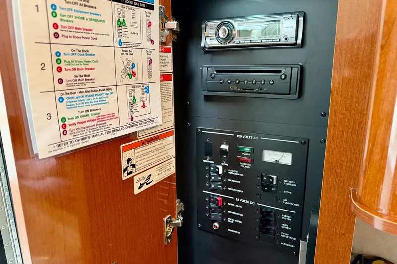 Slide: The Image of Control panel of a 2012 Sea Ray Sundancer 280 boat with stereo system and circuit breakers. - 40