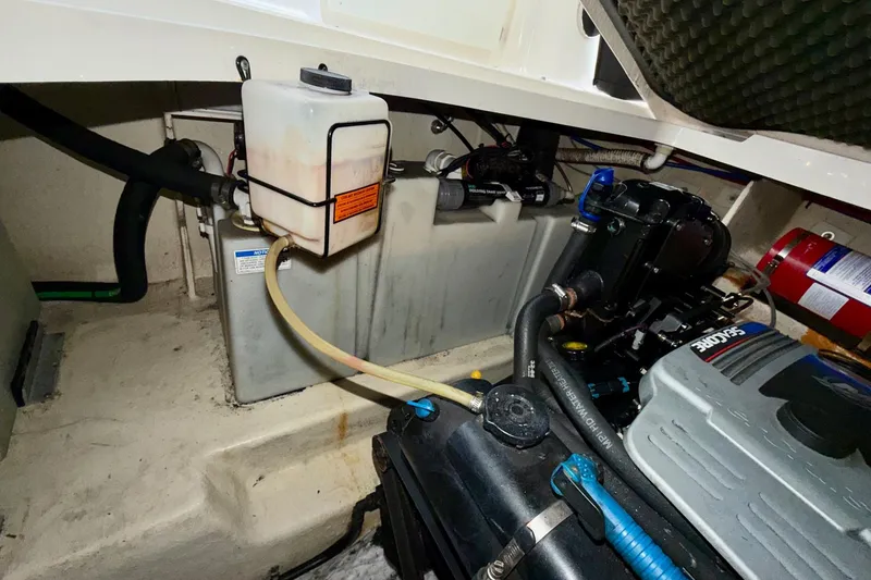 Slide: The Image of Engine compartment of 2012 Sea Ray Sundancer 280 with visible components and fire extinguisher. - 45