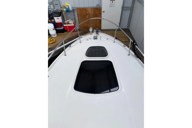 Slide: The Image of 2012 Sea Ray Sundancer 280 boat deck with hatches, docked in a marina. - 47