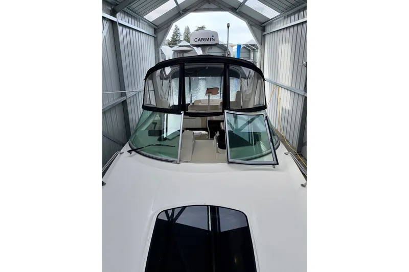 Slide: The Image of 2012 Sea Ray Sundancer 280 in covered dock, featuring Garmin equipment. - 49