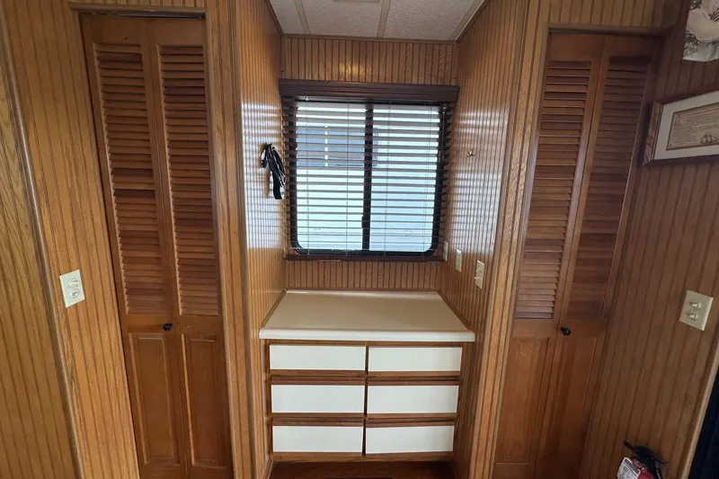 Slide: The Image of Interior of 1993 Sumerset 14x65 houseboat with wood paneling and storage drawers. - 12