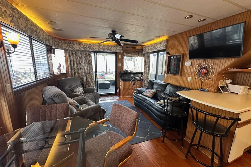 Slide: The Image of Interior of a 1993 Sumerset 14x65 houseboat with cozy seating and modern amenities. - 3
