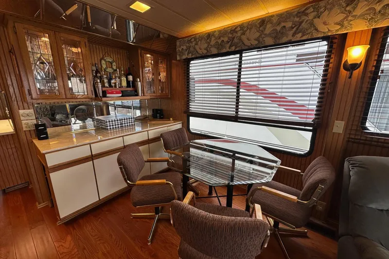 Slide: The Image of Interior of 1993 Sumerset 14x65 houseboat with dining area and wooden cabinetry. - 5