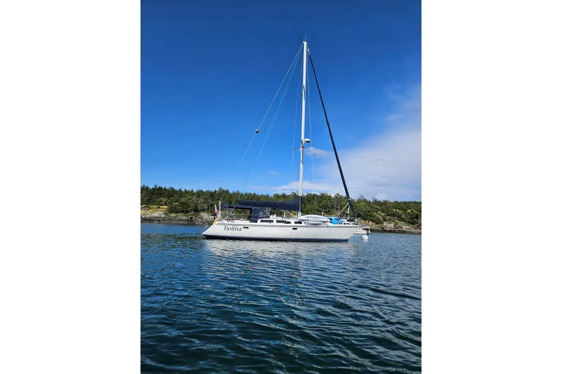 The Image of Sailboat Catalina 42 (1992) anchored on calm water under clear blue sky. - 0